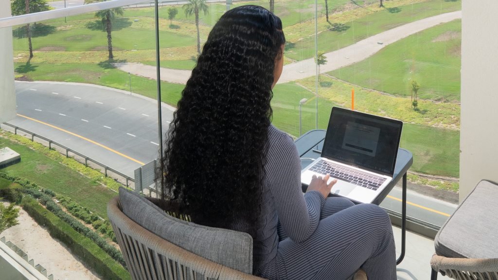 a woman sitting in a chair with a laptop